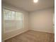 Bright bedroom with carpet floors and a large window bringing in natural light at 2323 Hunter Woods Dr # 566, Apex, NC 27502