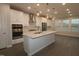 Spacious kitchen featuring a large island, stainless appliances, and ample natural light at 2323 Hunter Woods Dr # 566, Apex, NC 27502