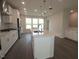 Open kitchen layout with a large center island, modern appliances, and hardwood flooring at 2323 Hunter Woods Dr # 566, Apex, NC 27502