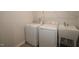 Modern laundry room featuring a washer, dryer, utility sink, and wire shelving at 2323 Hunter Woods Dr # 566, Apex, NC 27502