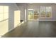 Sunlit living area with hardwood floors, access to a deck, and contemporary design at 2323 Hunter Woods Dr # 566, Apex, NC 27502