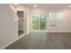 Bright living room with hardwood floors, sliding glass doors to the deck, and neutral paint at 2323 Hunter Woods Dr # 566, Apex, NC 27502