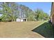 A Large backyard with outbuilding features an open green space perfect for outdoor activities and entertainment at 2624 Gary Rd, Rocky Mount, NC 27803