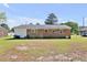 Spacious backyard features a brick house, green grass, and ample room for outdoor activities at 2624 Gary Rd, Rocky Mount, NC 27803
