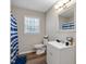 Bathroom with a classic design featuring wood-look floors, vanity sink, mirror, and toilet at 2624 Gary Rd, Rocky Mount, NC 27803
