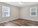 Bright bedroom with laminate floors and two large windows providing ample natural light at 2624 Gary Rd, Rocky Mount, NC 27803