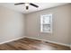 A bright bedroom with wood-look floors, a ceiling fan and plenty of natural light from a window at 2624 Gary Rd, Rocky Mount, NC 27803