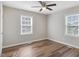 Bright bedroom with wood-look floors and two windows providing plenty of natural light at 2624 Gary Rd, Rocky Mount, NC 27803