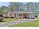 Well-maintained home offers brick facade, established landscaping, and attached carport on a large lot at 2624 Gary Rd, Rocky Mount, NC 27803