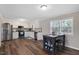 Spacious kitchen features stainless appliances, a breakfast table, white cabinets, and wood-look floors at 2624 Gary Rd, Rocky Mount, NC 27803