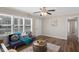 Living room with wood-look floors is bathed in natural light, featuring an adjacent doorway and piano at 2624 Gary Rd, Rocky Mount, NC 27803