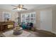 Living room bathed in natural light features wood-look floors, a cozy sofa, and a charming piano at 2624 Gary Rd, Rocky Mount, NC 27803