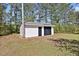 Outbuilding nestled in a lush backyard setting offers extra storage or a potential workshop space at 2624 Gary Rd, Rocky Mount, NC 27803