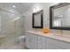 Bright bathroom featuring double vanities, glass shower, and luxurious finishes at 2701 Glenwood Gardens Ln, Raleigh, NC 27608