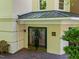 Attractive building entrance with glass doors and manicured landscaping at 2701 Glenwood Gardens Ln, Raleigh, NC 27608