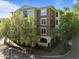 Beautiful brick apartment building with lush landscaping on a sunny day at 2701 Glenwood Gardens Ln, Raleigh, NC 27608