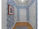 Bright hallway with blue patterned wallpaper, hardwood floors, and crisp white doors and trim at 2701 Glenwood Gardens Ln, Raleigh, NC 27608