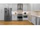 Well-equipped kitchen boasts stainless steel appliances, white cabinetry, and ample counter space; perfect for cooking at 2701 Glenwood Gardens Ln, Raleigh, NC 27608
