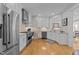 Modern kitchen features stainless steel appliances, white cabinetry, and a light-filled window; stylish and functional design at 2701 Glenwood Gardens Ln, Raleigh, NC 27608