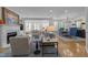 Open-concept living room featuring a fireplace, comfortable seating, and a seamless flow into the dining area at 2701 Glenwood Gardens Ln, Raleigh, NC 27608