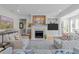 Elegant living room with a fireplace, artwork, and open layout to other areas at 2701 Glenwood Gardens Ln, Raleigh, NC 27608