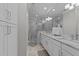 Elegant main bathroom with a glass-enclosed shower, double vanity, and marble countertops; luxurious and bright at 2701 Glenwood Gardens Ln, Raleigh, NC 27608