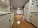 Bright kitchen featuring white cabinets, laminate floors, and modern appliances at 2710 Delaney Dr, Burlington, NC 27215