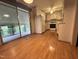 Bright kitchen featuring white cabinets, laminate floors, and access to the backyard through a sliding glass door at 2710 Delaney Dr, Burlington, NC 27215