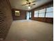 A bright living room featuring brick accent wall and carpeted floors at 2710 Delaney Dr, Burlington, NC 27215