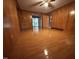 A bright living room featuring wood paneling and hardwood floors at 2710 Delaney Dr, Burlington, NC 27215