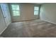 Empty bedroom with carpet, two windows, and neutral-colored walls, ready for personalization at 2723 Hunter Woods Dr # 566, Apex, NC 27502
