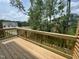 Wooden deck with railing showcasing a view of a green landscape at 2723 Hunter Woods Dr # 566, Apex, NC 27502