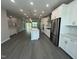 Open-concept kitchen with white cabinets, stainless steel appliances, and a spacious island at 2723 Hunter Woods Dr # 566, Apex, NC 27502