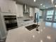 Close up of a kitchen showcasing an island with a stainless steel sink and modern appliances at 2723 Hunter Woods Dr # 566, Apex, NC 27502