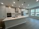 Modern kitchen featuring white cabinets, stainless steel appliances, and a large center island at 2723 Hunter Woods Dr # 566, Apex, NC 27502