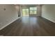Spacious living room with wood floors and a sliding glass door leading to the outside at 2723 Hunter Woods Dr # 566, Apex, NC 27502