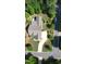 Aerial view of the home with a long driveway, manicured lawn, and beautiful landscaping at 277 High Ridge Ln, Pittsboro, NC 27312