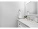 Bathroom features a marble countertop, classic fixtures, a white vanity, and a decorative mirror at 277 High Ridge Ln, Pittsboro, NC 27312