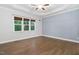 Bright bedroom with trey ceiling, hardwood floors, a large window, and board and batten accent wall at 277 High Ridge Ln, Pittsboro, NC 27312