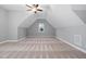 Large bonus room with a ceiling fan and plenty of natural light from the window on the far wall at 277 High Ridge Ln, Pittsboro, NC 27312