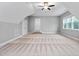 Spacious bonus room with neutral paint, patterned carpet, ceiling fan, and natural light from a window at 277 High Ridge Ln, Pittsboro, NC 27312