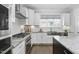 Bright kitchen features granite counters, stainless steel appliances, large window, and white subway tile backsplash at 277 High Ridge Ln, Pittsboro, NC 27312