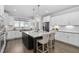 Open kitchen featuring stainless appliances, granite counters, island seating, and white cabinets at 277 High Ridge Ln, Pittsboro, NC 27312