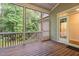 Screened-in porch with wood flooring and a view of the lush green backyard at 277 High Ridge Ln, Pittsboro, NC 27312
