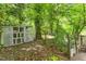 Backyard view showcasing a garden shed and wooded area, providing a private outdoor space at 2904 Sprucewood Dr, Durham, NC 27707
