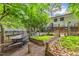 The backyard area shows gardening opportunities with wooden planters and access to an elevated deck space at 2904 Sprucewood Dr, Durham, NC 27707