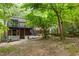 A serene backyard featuring a deck, brick accents, and lush greenery at 2904 Sprucewood Dr, Durham, NC 27707