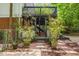 Backyard space featuring a covered patio, brick accents, and lush landscaping at 2904 Sprucewood Dr, Durham, NC 27707