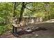 Backyard with an outdoor fire pit and bench seating, a relaxing gathering area for tranquil enjoyment at 2904 Sprucewood Dr, Durham, NC 27707