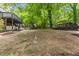 Large backyard space with a covered structure, lush landscaping, and room to roam at 2904 Sprucewood Dr, Durham, NC 27707